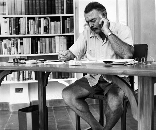 Hemingway_at_his_writing_desk_