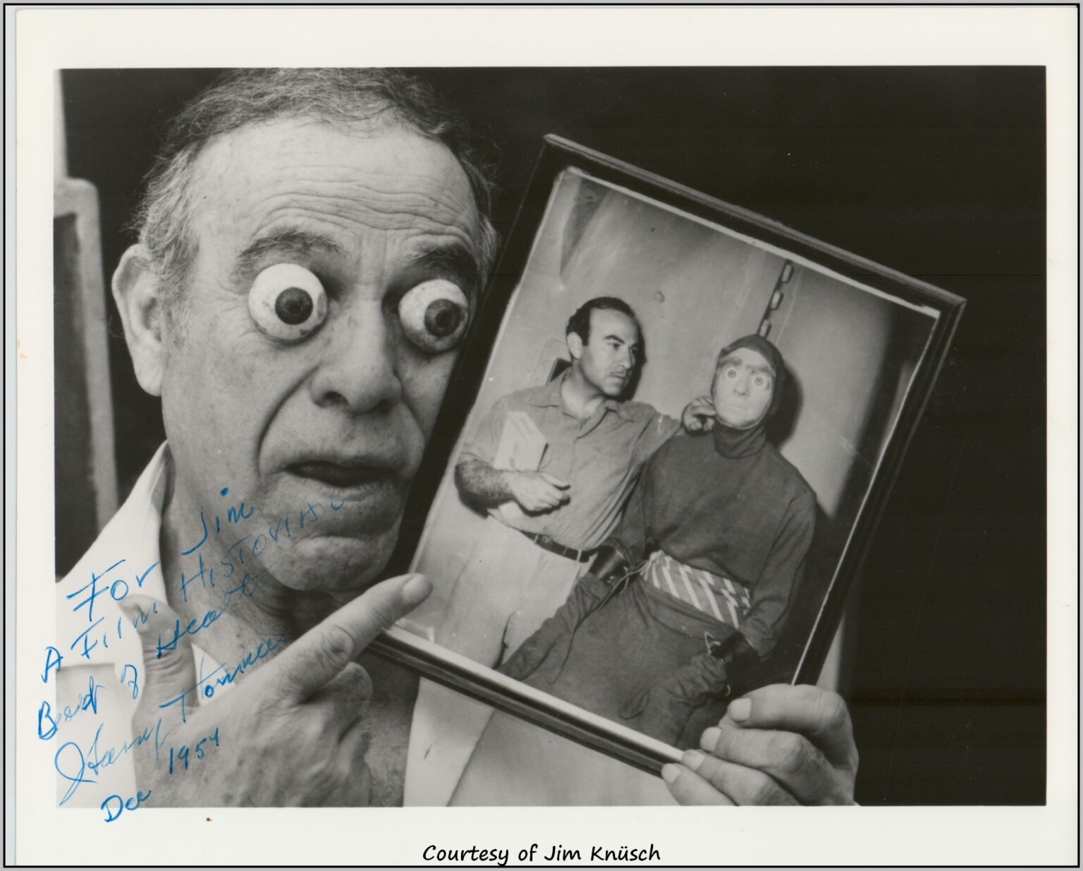 Harry Thomas makeup man holding photograph of alien from Killers from Space.
