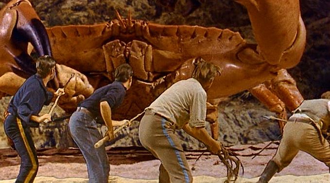 The most famous scene from Mysterious Island: the giant crab attacks. Mysterious Island action shot of men fighting back screen projected crab monster.