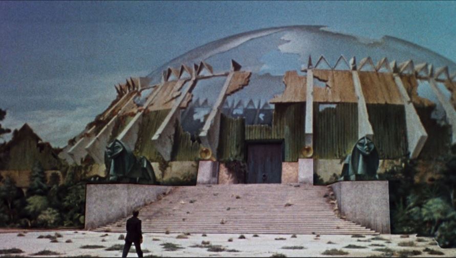 A nice composite shot featuring a matte painting by Bill Brace combined with a live shot of Rod Taylor and steps filmed on the studio lot. A nice composite shot featuring a matte painting by Bill Brace combined with a live shot of Rod Taylor and steps filmed on the studio lot.