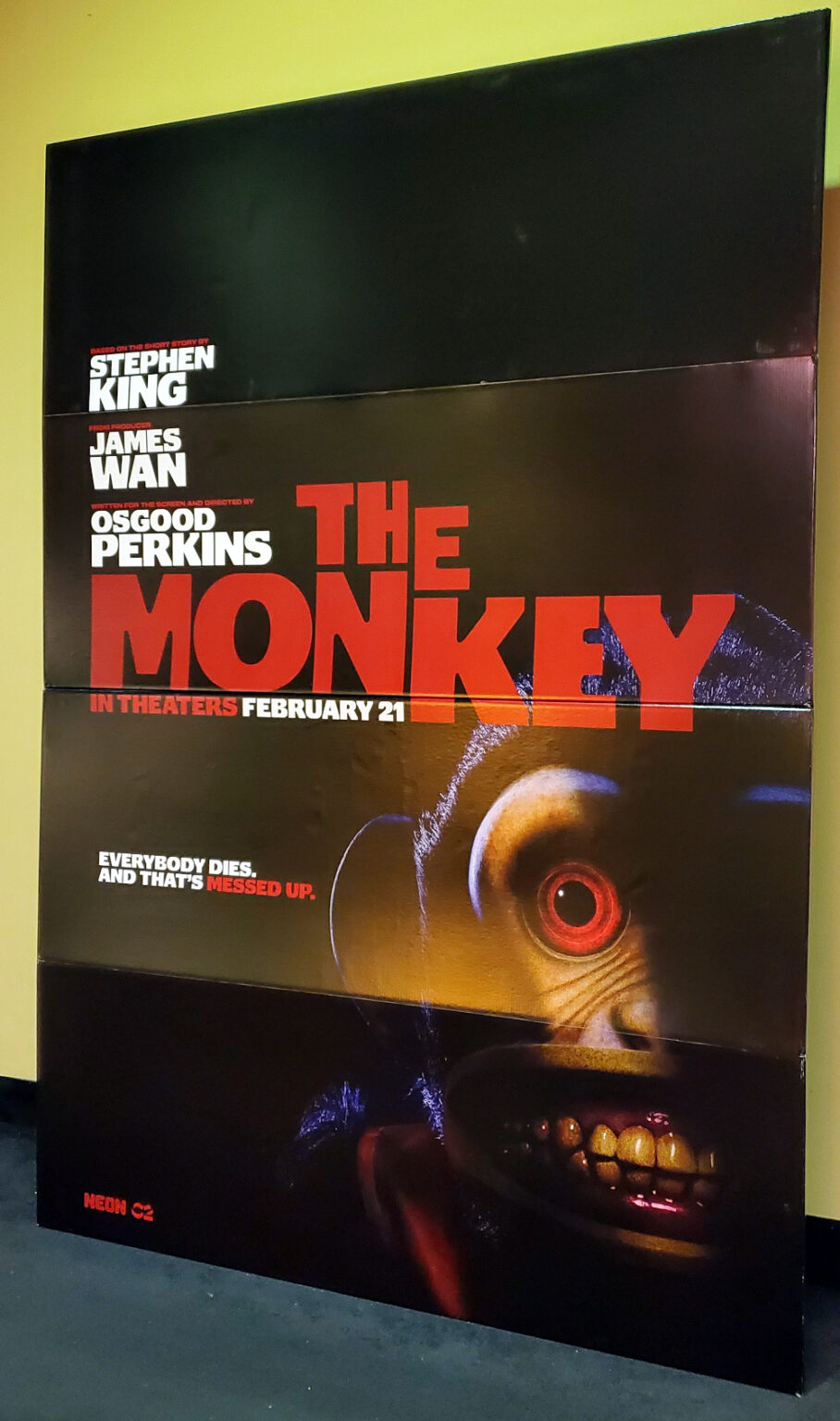 The Monkey movie standee showing a scary monkey face in shadow