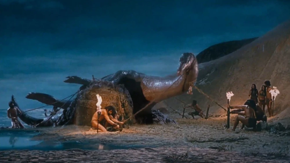 When Dinosaurs Ruled the Earth The highlight scene of the movie! A glass painting of the background with a rear projected insert of water at the lower left, the rear projected plate of the main cavemen action with wire ropes, animated caveman with wire rope at the lower left, model Plesiosaur inserted via a Dynamation-type process which brings the kneeling caveman to the front of the model, a glass positioned flat in front to capture reflections, and foreground artwork all work together to produce a convincing spectacle. The concentration, attention to lighting detail, and pattern of execution of all the processes is something Jim Danforth excelled in.