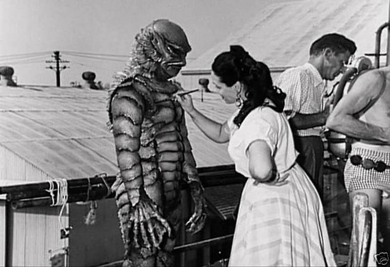 One of a series of publicity stills created to demonstrate how the 3D effect would appear to theater audiences. A similar set was produced for It Came From Outer Space. Millicent Patrick applies a little touch-up to the creature suit worn by Ricou Browning who portrayed the creature in the underwater scenes.