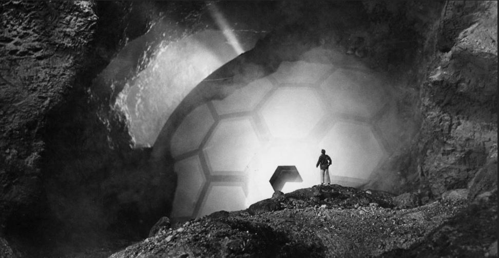 A neat miniature shot of the crashed spaceship with a to-scale Richard Carlson. When the door slams shut a landslide is triggered burying the ship in tons of debris. An impressive sequence! A neat miniature shot of the crashed spaceship with a to-scale Richard Carlson. When the door slams shut a landslide is triggered burying the ship in tons of debris. An impressive sequence!