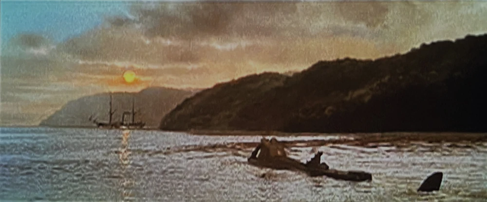 Impending doom! One of the best model shots in the movie. Filmed in 20th Century Fox’s Sersen tank, the 22-foot Nautilus model slowly picks up speed as the nitrate ship leaves the harbor, unaware of the terror that is about to ram and sink it. Beautifully executed composite shot of a painted hill behind the distant nitrate ship model, a spotlight casting a reflection on the water, a cutout hill positioned at the right to give a reflection in the water, and a Peter Ellenshaw glass painting of the sky, sun and detailed front hill blending it all together and hiding the spotlight. This shot was done in one pass on the original negative. Impending doom! One of the best model shots in the movie. Filmed in 20th Century Fox’s Sersen tank, the 22-foot Nautilus model slowly picks up speed as the nitrate ship leaves the harbor, unaware of the terror that is about to ram and sink it. Beautifully executed composite shot of a painted hill behind the distant nitrate ship model, a spotlight casting a reflection on the water, a cutout hill positioned at the right to give a reflection in the water, and a Peter Ellenshaw glass painting of the sky, sun and detailed front hill blending it all together and hiding the spotlight. This shot was done in one pass on the original negative.